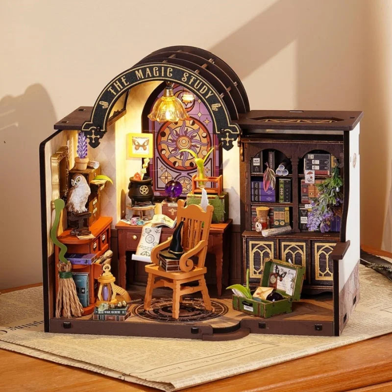 Miniature magic study room diorama with wooden furniture, bookshelves, and wizard decor.